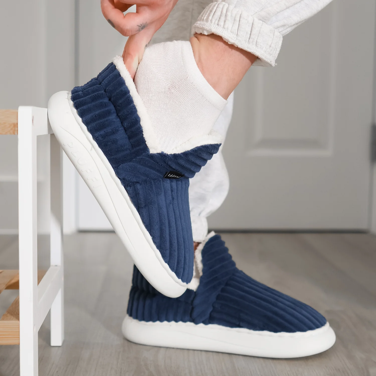 Blue LUFFLI-style slippers worn indoors
